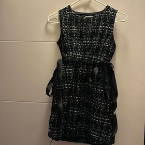 It’s mini black dress with the bow on the size. New condition guaranteed
